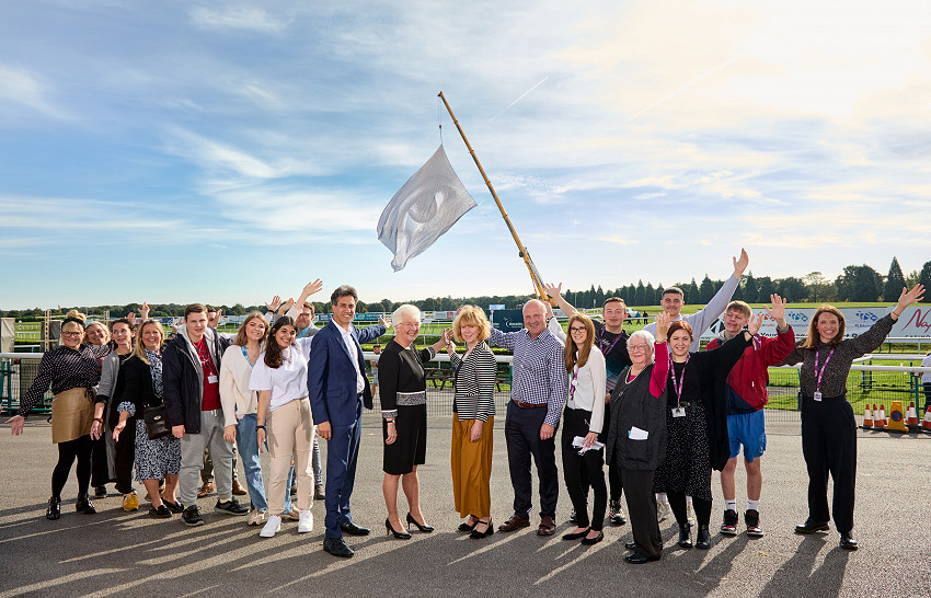 Image of people with We Are Watching flag