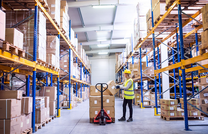 Female warehouse worker loading boxes