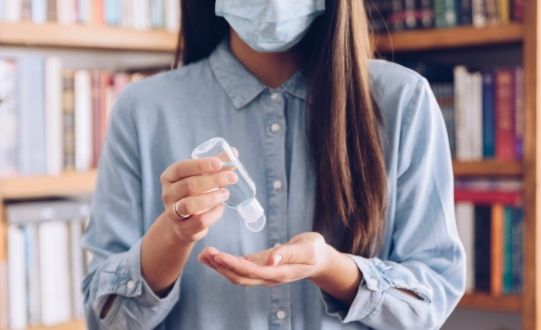 Lady with hand sanitiser and mask