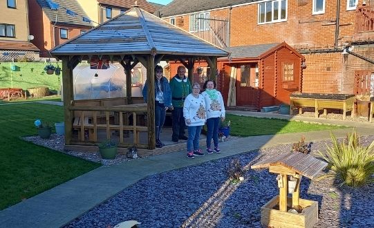 Community Connect service users enjoying their new garden pagoda